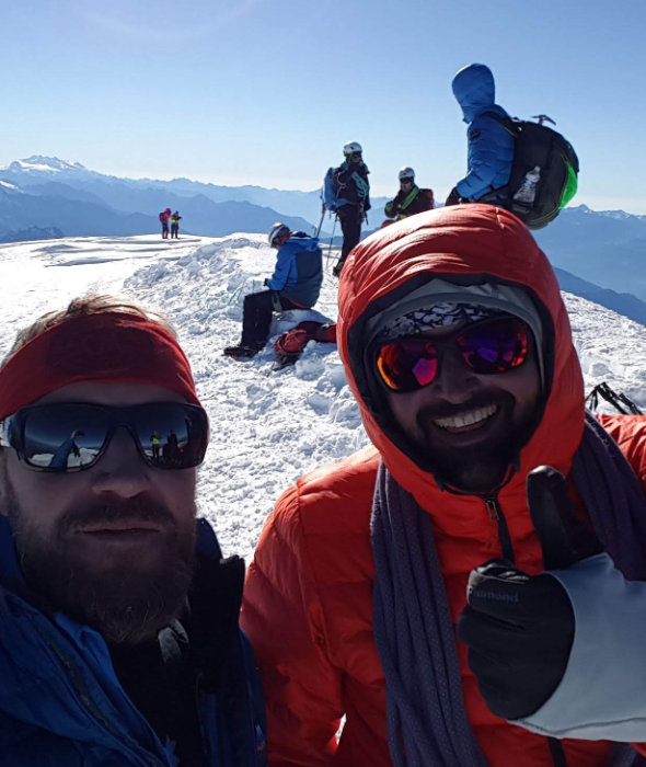 Happy mountaineers on the summit of Mont Blanc